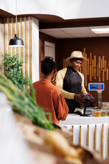 Wall Mural - While shopping for fresh products, a black woman is helped by a male vendor. The shopkeeper provides a choice of vivid and healthful alternatives, resulting in a pleasant shopping experience.