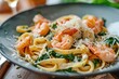 Tasty pasta with spinach and shrimp topped with grated parmesan cheese