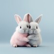 Two cute baby bunnies hugging each other on a blue pastel background. Creative Valentine's Day romantic concept.	