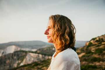 Wall Mural - woman tourist relaxing and watching rocks in the sea