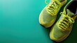 Bright yellow running shoes on a green background