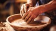 Closeup of a potters hands shaping clay on a pottery wheel.