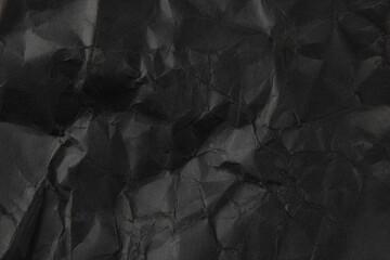 Wall Mural - crumpled black paper texture background.