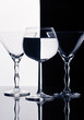 Three wine glasses isolated on black and white splited background
