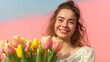 a woman smiles with tulips outside