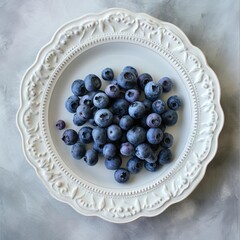 Wall Mural - Fresh Ripe blueberries on a white porcelain plate