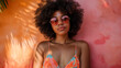 © Padirac - ethnic woman in bikini with sunglasses and afro in front of a colorful wall