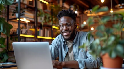 Poster - Realistic photo concept of a man in an office, sitting at a desk and smiling pleasantly while working on a laptop Generative AI