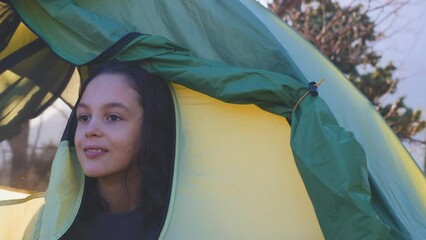 Sticker - The child woke up in the tent and comes out of it. boy resting in a tent. Hiking in the mountains with a child. active lifestyle.