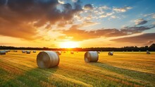 Large Rolls Of Hay In The Field After Harvest. Rural Landscape With Rolled Hay In Ripe Wheat Field.sunset,sunrise Background