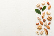 © sosiukin - Composition of nuts , flat lay - mix hazelnuts, cashews, almonds on table background. healthy eating concepts and food background