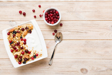 Wall Mural - Healthy breakfast food with granola, yogurt, fruits and nuts. Dessert parfait with dried fruits for breakfast