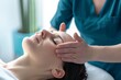 © ARTIFICIAN - physiotherapist or chiropractor conducting cranial sacral therapy on a woman patient. therapeutic process, showcasing the activation of the trigeminal nerve.