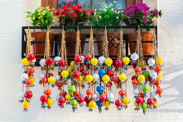 Wall Mural - Bundles of multicolored ceramic pomegranates. House decoration and amulets outside the window. Public space. Side city (Manavgat), Turkey (Turkiye)