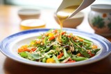 miso dressing drizzled over asian-style salad