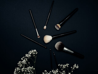 Makeup brushes on a black background