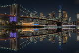 Fototapeta  - view of the brooklin bridge at night with reflections. manhattam skyline, brooklyn bridge. New York City