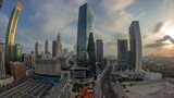 Fototapeta Miasto - Panorama of Dubai International Financial district aerial night to day timelapse. View of business office towers.