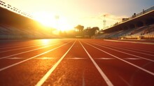 Sunlit Athletic Running Track In Stadium. Sunlit Markings Of A Racetrack In A Stadium
