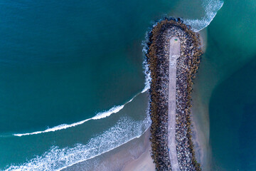 Fototapete - zenithal aerial drone view of a concrete block breakwater. Vila Praia de Ancora, Portugal