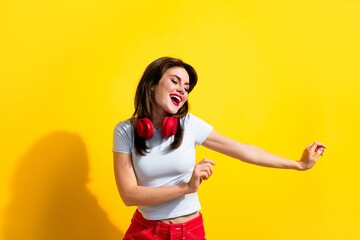 Poster - Photo of pretty funky woman dressed white t-shirt headphones dancing discotheque isolated yellow color background