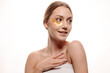 © rostyslav84 - Beauty portrait of a beautiful woman applying gel eye patches on her face on a white background
