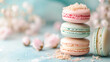 Almond  French Macaroon on top of each other on a pale blue background. with pink roses.  Abstract background with macaron & flower with copy space.