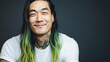 Smiling asian man with long dyed hairs. 