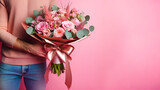 Fototapeta  - hand holding pink bouquet on pink background