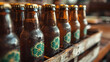 A group of beer bottles covered in water droplets, each adorned with four-leaf clover logos, in wooden box, waiting to celebrate St. Patrick's Day.