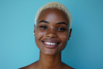 Aufkleber - A woman with short blonde hair smiling directly at the camera. This image can be used for various purposes