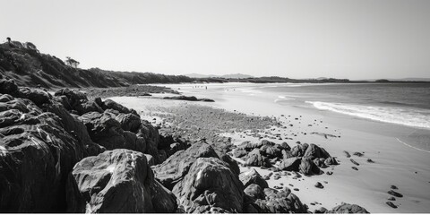 Poster - A black and white photo capturing the beauty of a rocky beach. Perfect for adding a touch of elegance to any project