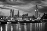 Fototapeta Boho - View of Westminster palace and bridge over river Thames with Big Ben illuminated at night in London, UK