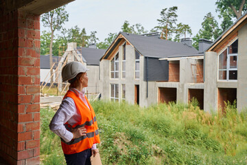 Building inspector conducting visual inspection of residential development site