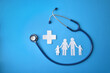 Family health concept with stethoscope cutouts on blue background