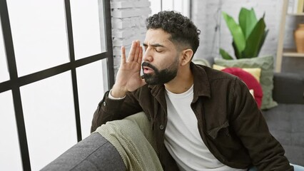 Sticker - Furious young man, raising hand to mouth, passionately shouting to his side at home - an intense demonstration of emotion and vocal communication.