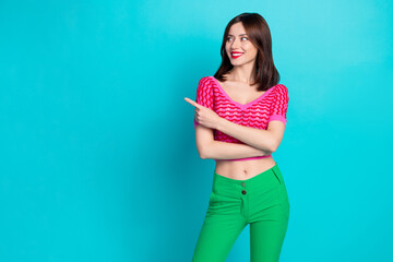 Wall Mural - portrait of cheerful gorgeous woman with stylish hair wear pink top directing look at offer empty sp