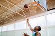 © Marko Geber - Man Scoring Basket in Basketball Game Indoors