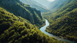 A panoramic shot of a tranquil river winding through a lush valley