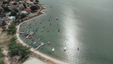 Fototapeta  - Serene Coastal Village: Aerial View of Boats and Sparkling Water