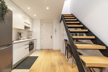 Wall Mural - small loft-type house with wooden and metal stairs to access the second floor