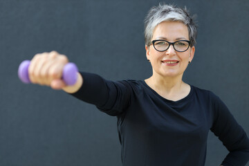 Sticker - Happy and healthy senior woman practicing fitness in nature, radiating vitality and promoting an active lifestyle in her retirement years.