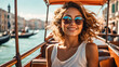 A girl in sunglasses and a sundress rides a gondola in Venice