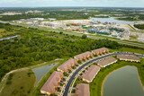 Fototapeta Morze - Aerial view of construction site with new tightly packed homes in Florida closed living clubs. Family houses as example of real estate development in american suburbs