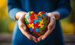 Hand holding colorful puzzle shaping love international autism day concept --ar 5:3