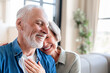 Love and care concept. Physical touch - love language. Caucasian senior old elderly spouses couple grandparents hugging embracing cuddling spending time together at home