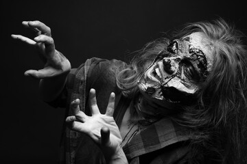  Scary zombie on dark background, black and white effect. Halloween monster