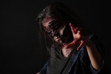 Wall Mural - Scary zombie on dark background. Halloween monster