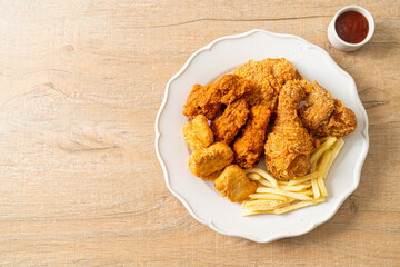 Canvas Print - fried chicken with french fries and nuggets on plate