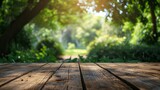 Fototapeta Natura - Wooden Table with a Blurry Garden Background in Morning Light